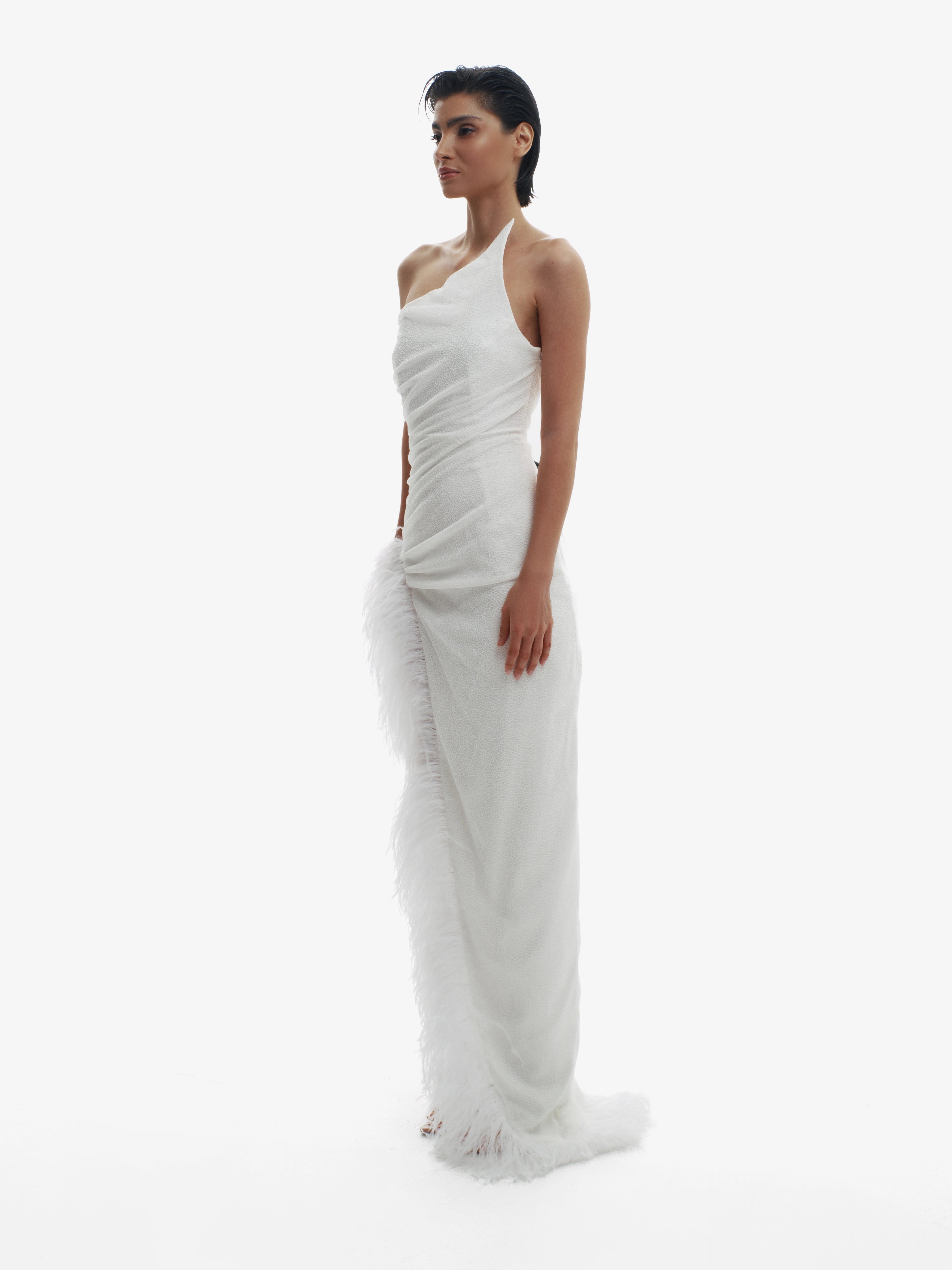 Woman wearing a white halter neck gown on a white background