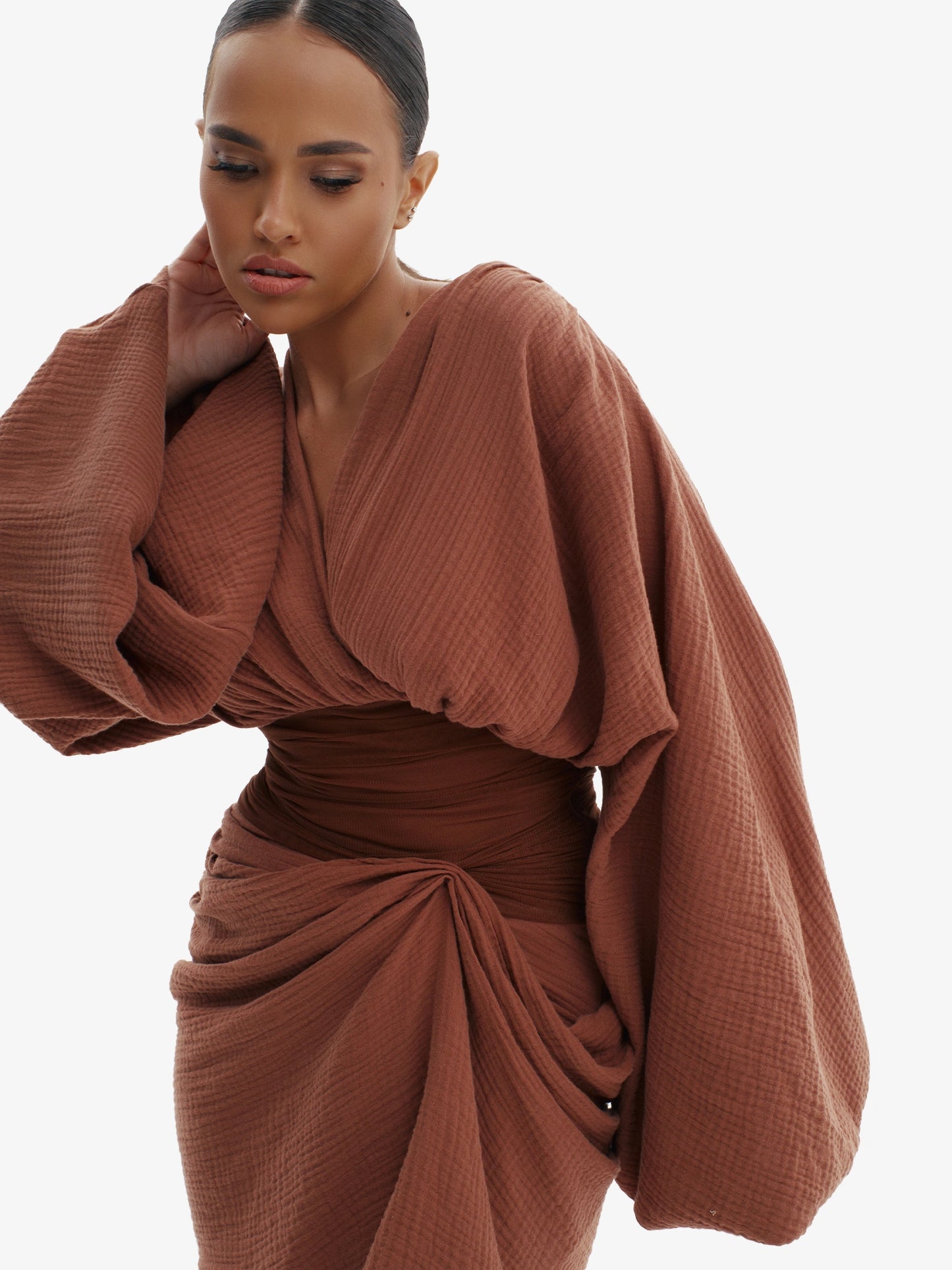 Brown draped dress with cinched waist, flattering minimalist elegance.