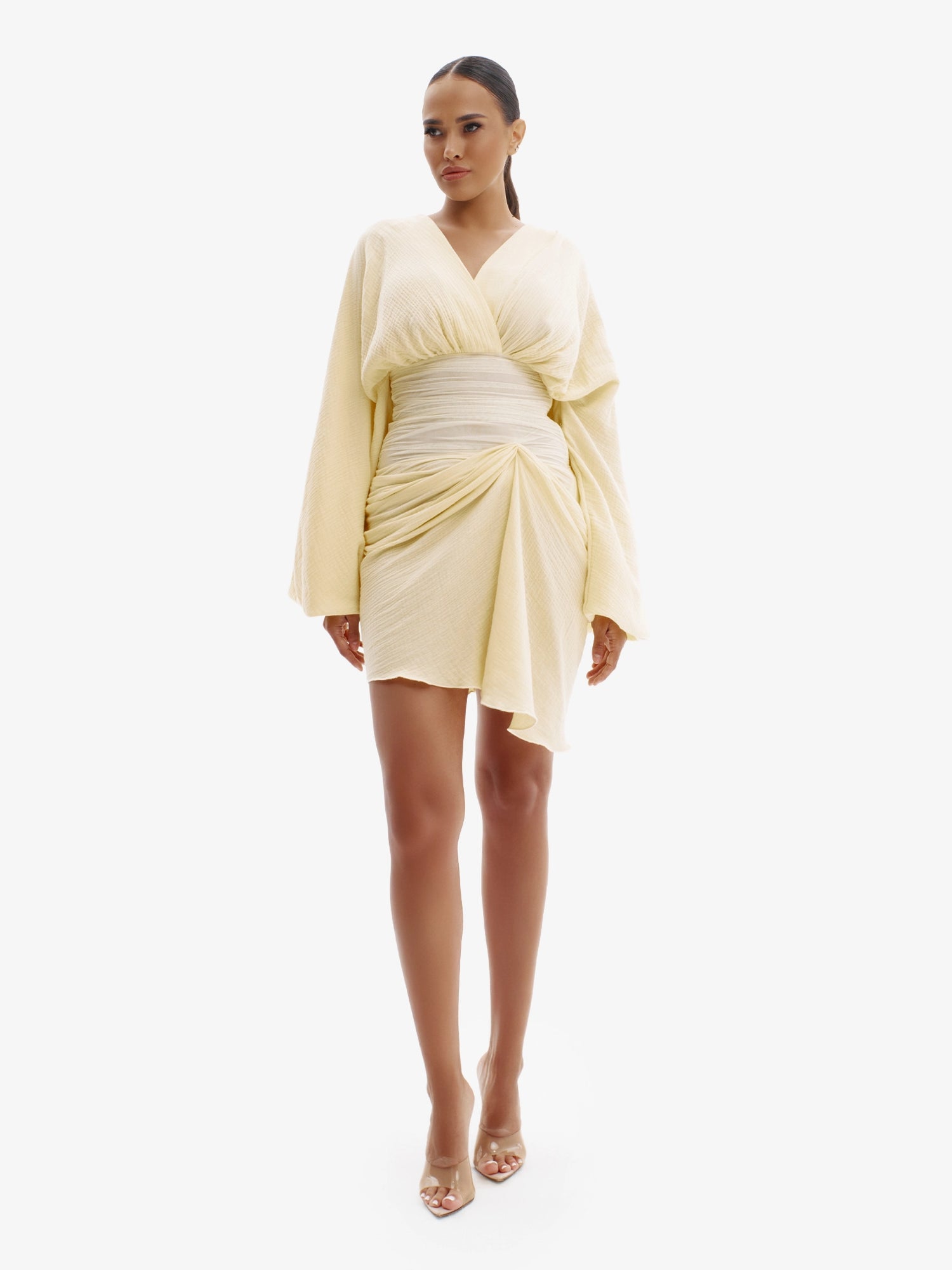 Pastel Yellow draped dress with cinched waist, flattering minimalist elegance.