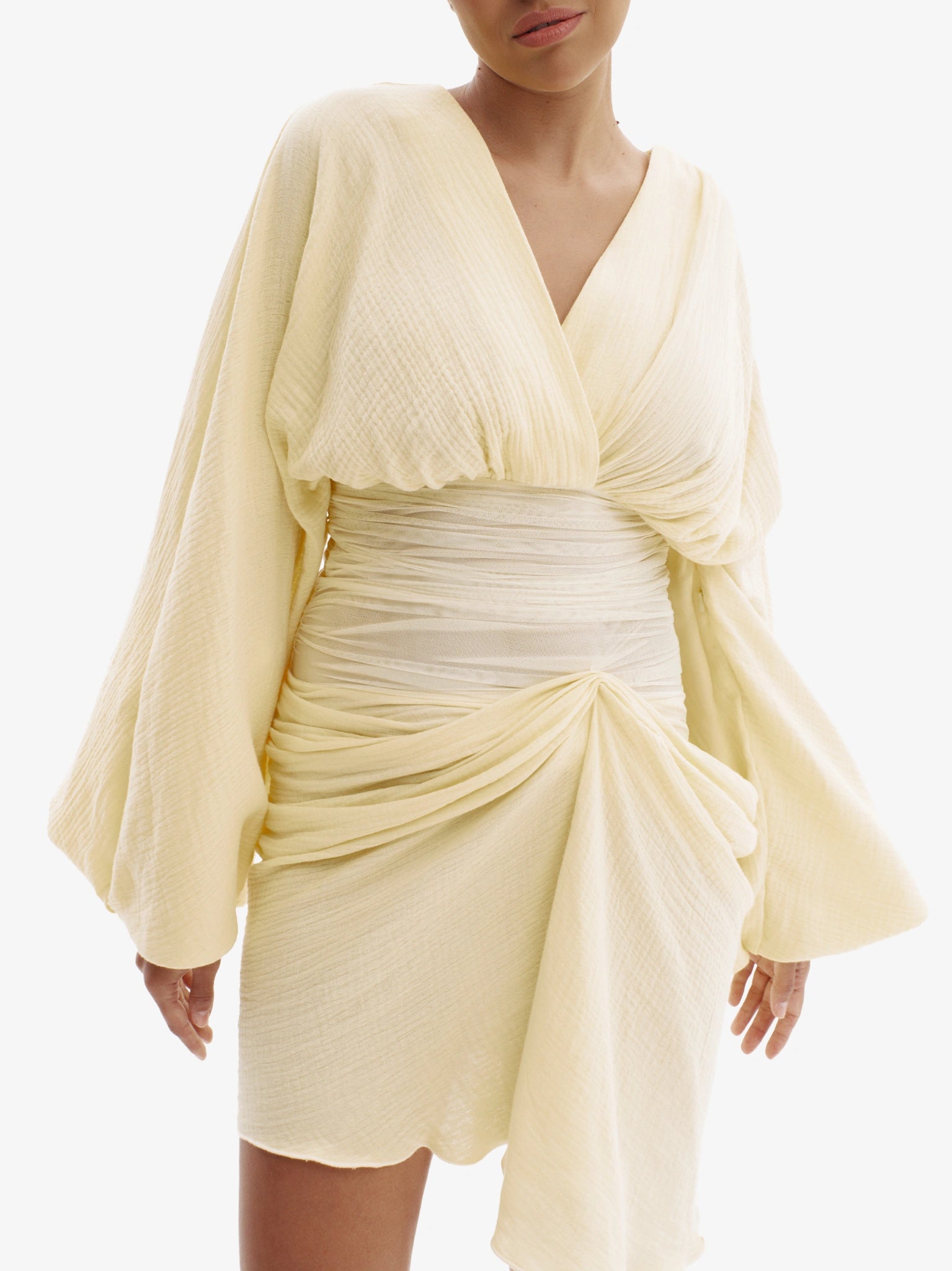 Pastel Yellow draped dress with cinched waist, flattering minimalist elegance.