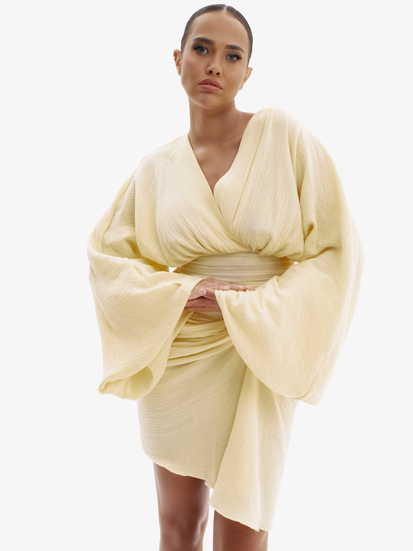 Pastel Yellow draped dress with cinched waist, flattering minimalist elegance.