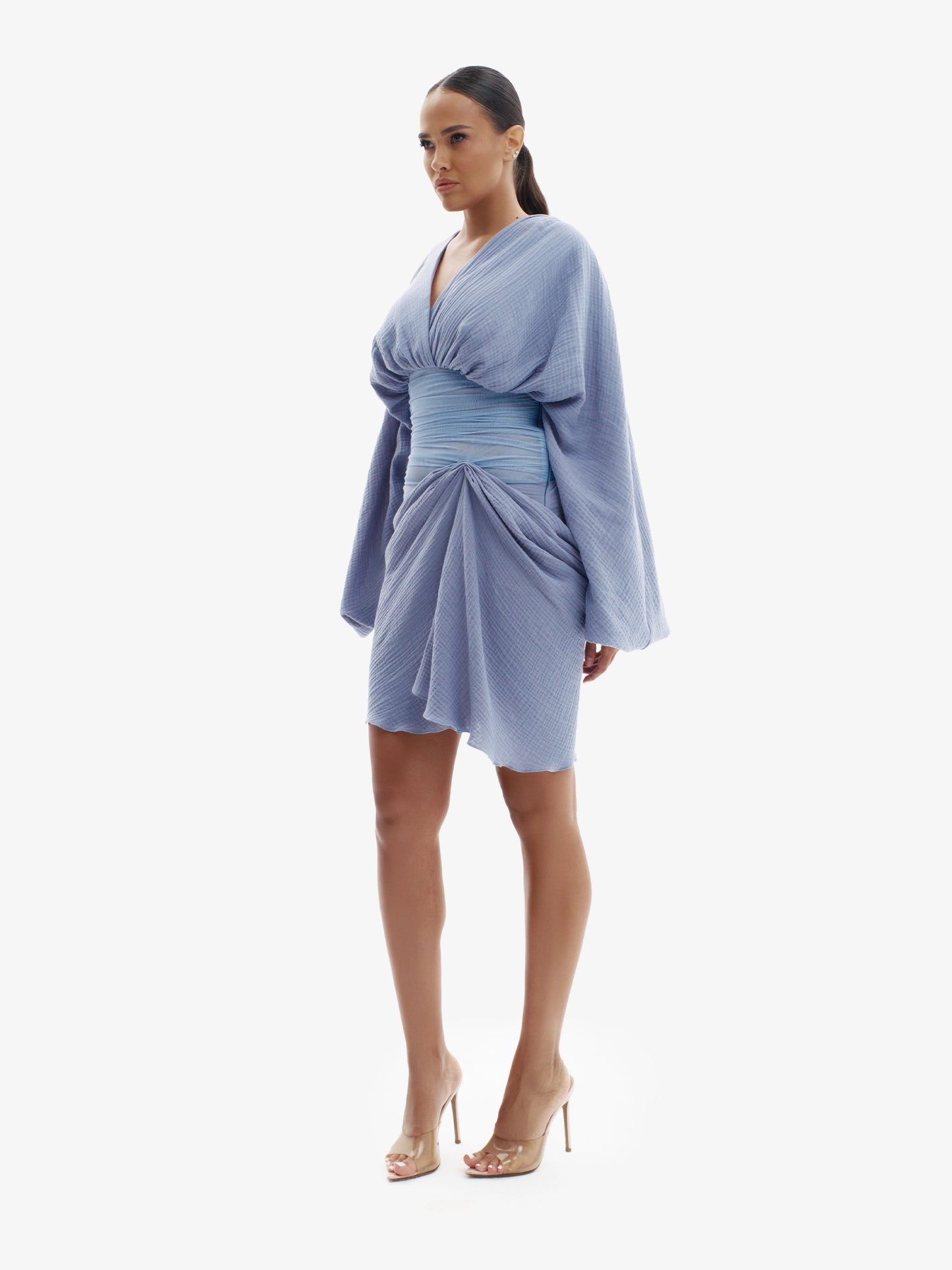 Blue draped dress with cinched waist, flattering minimalist elegance.