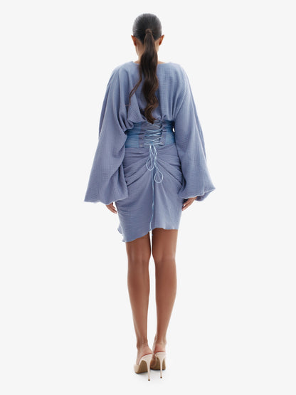 Blue draped dress with cinched waist, flattering minimalist elegance.