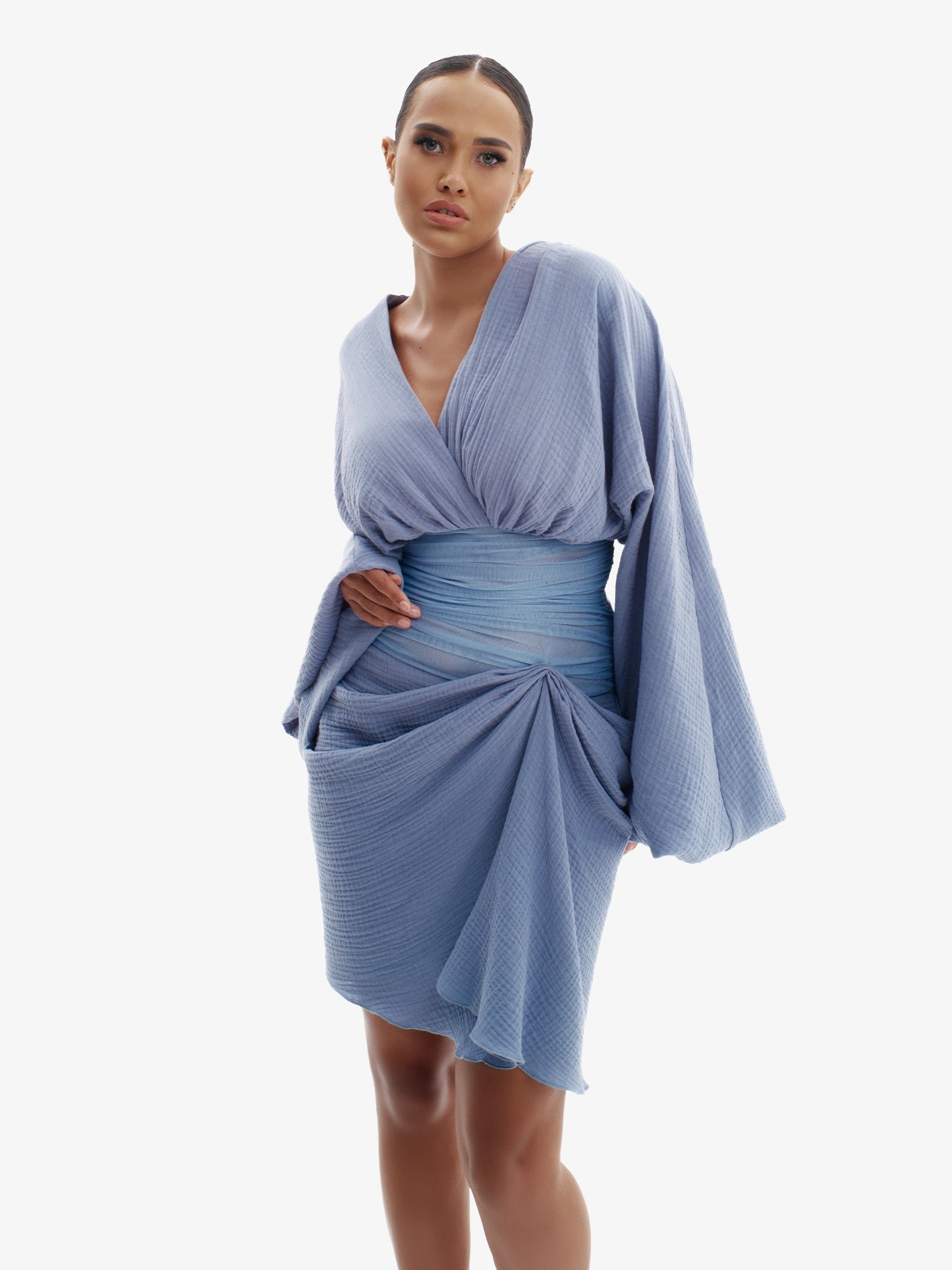 Blue draped dress with cinched waist, flattering minimalist elegance.