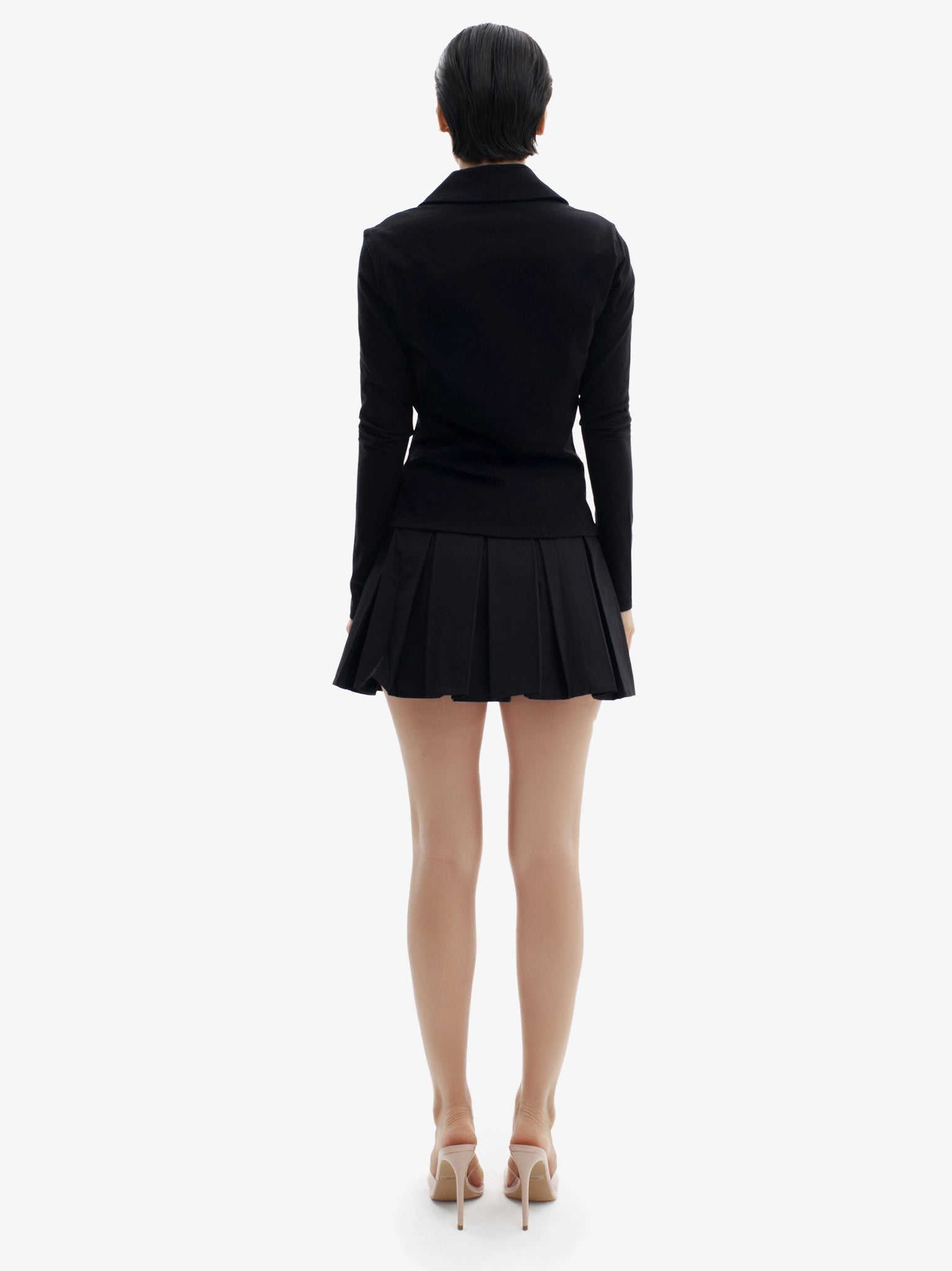 Black tennis skirt, elevated sport-chic, comfortable luxury minimalist athletic wear.