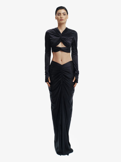 Black twisted knot maxi skirt, effortless draping, unique minimalist style.

