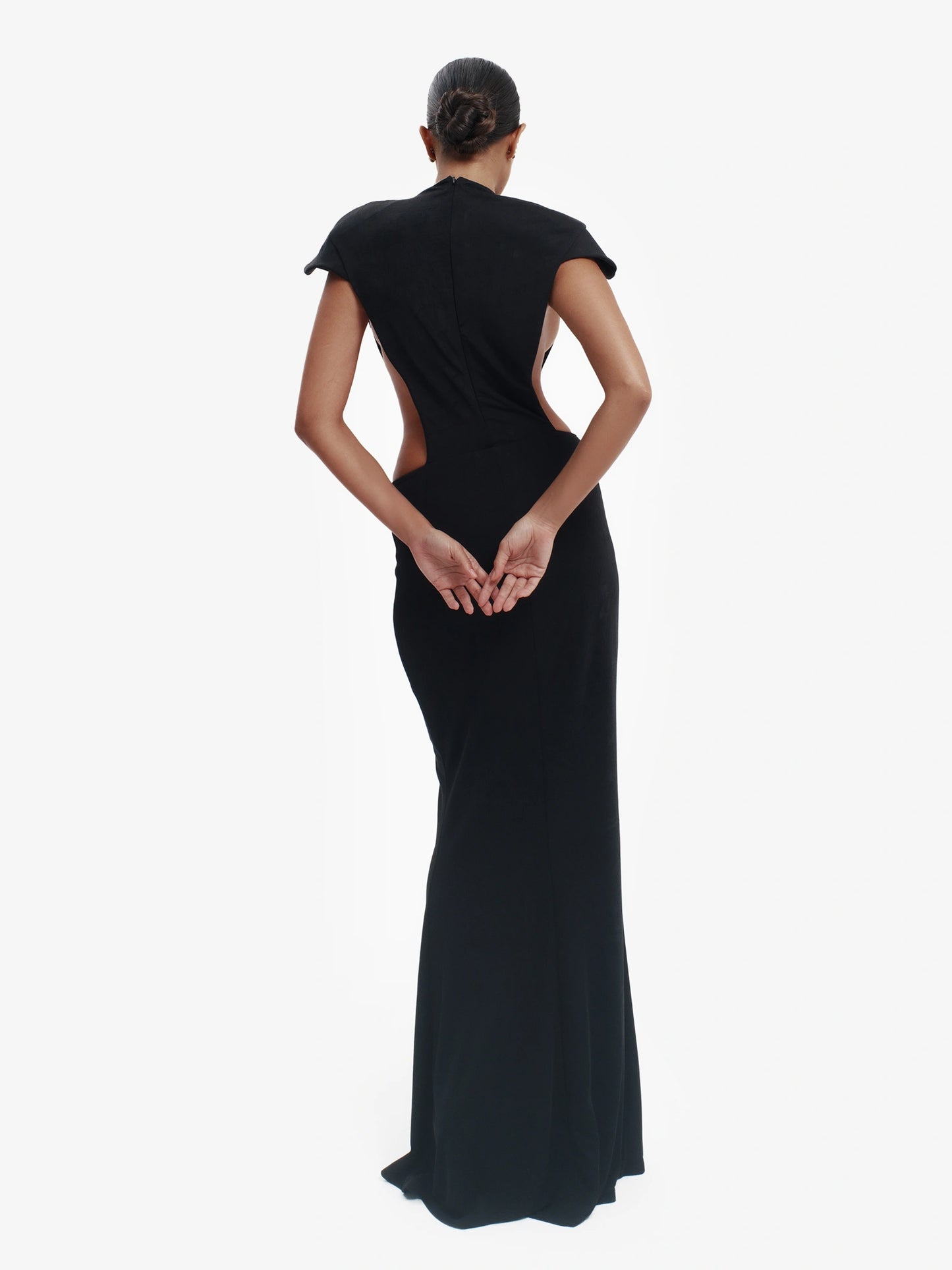 Black minimalist dress, unexpected side details, effortless modern chic.