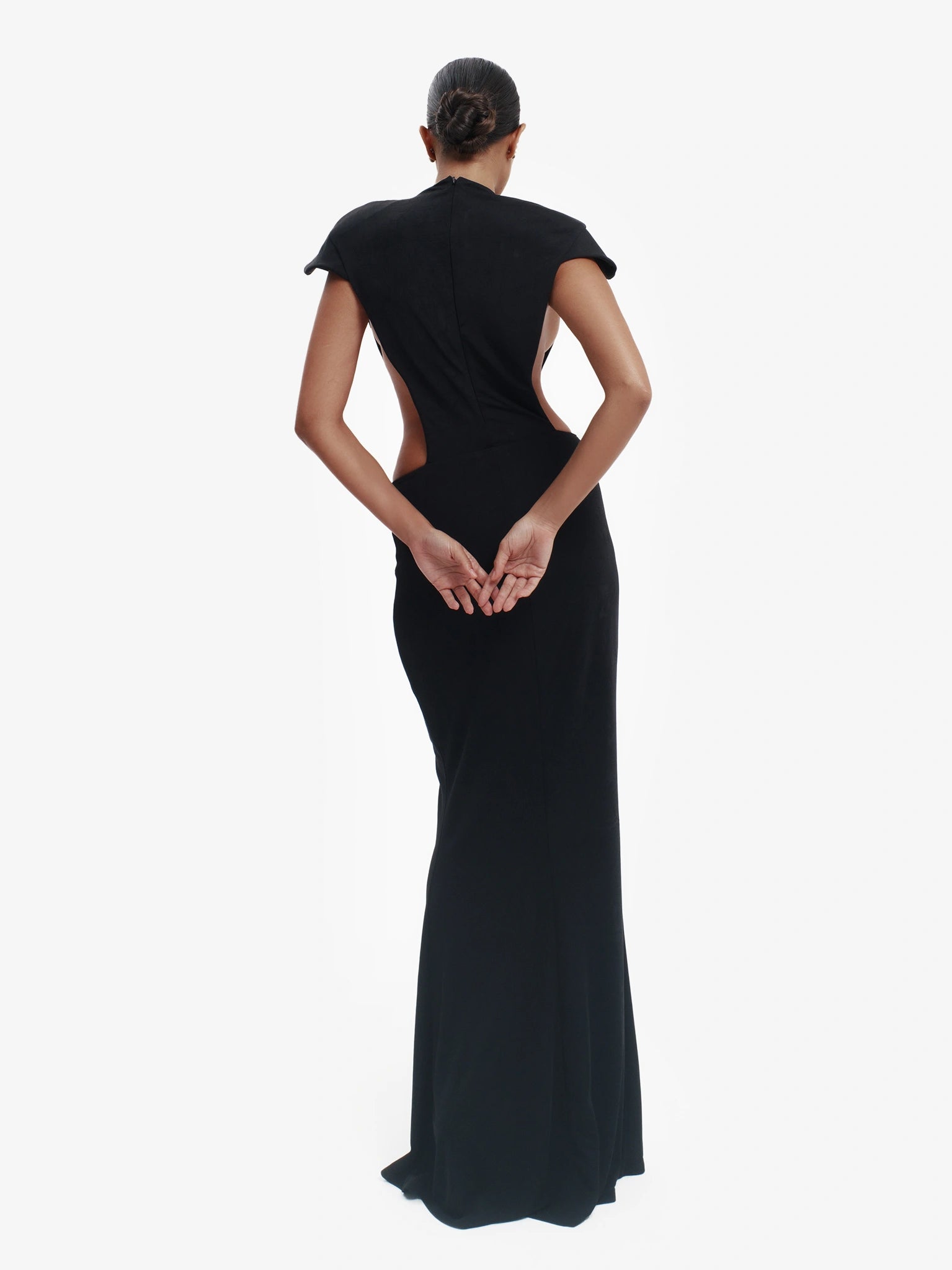 Black minimalist dress, unexpected side details, effortless modern chic.