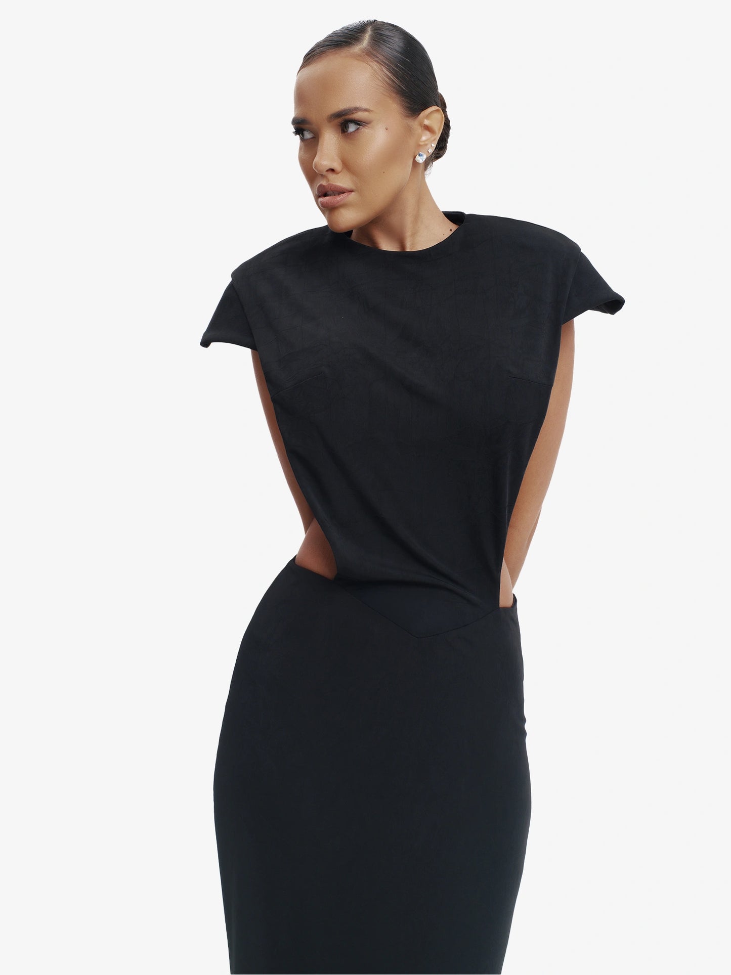 Black minimalist dress, unexpected side details, effortless modern chic.