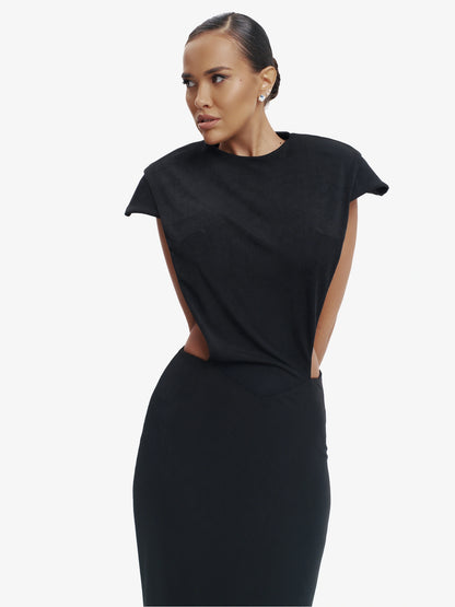 Black minimalist dress, unexpected side details, effortless modern chic.