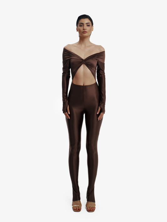 Brown statement jumpsuit, unapologetic style, confident luxury fashion.