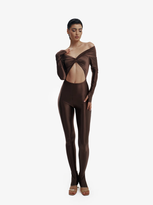 Brown statement jumpsuit, unapologetic style, confident luxury fashion.