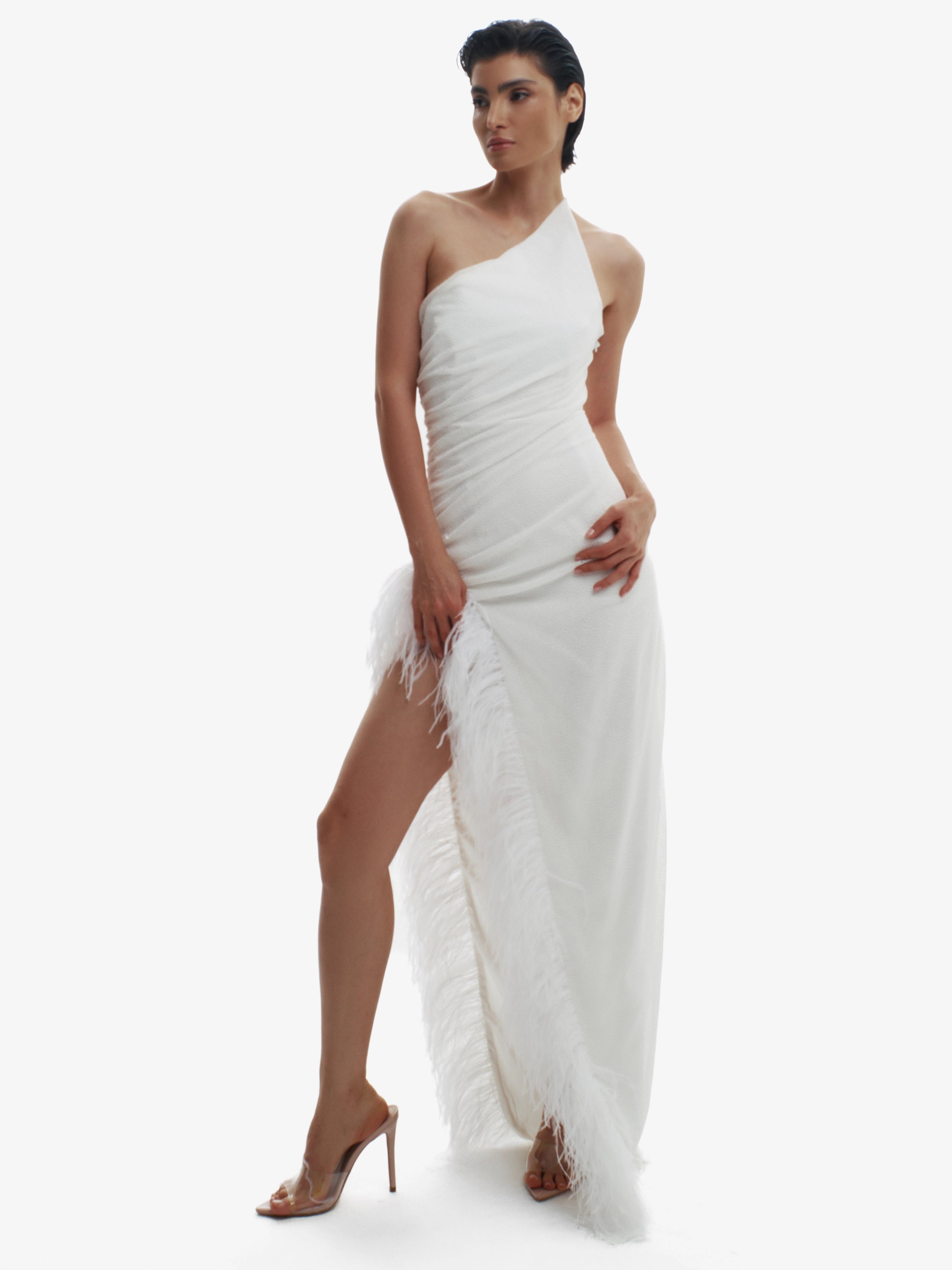 Woman wearing a white one-shoulder dress on a white background