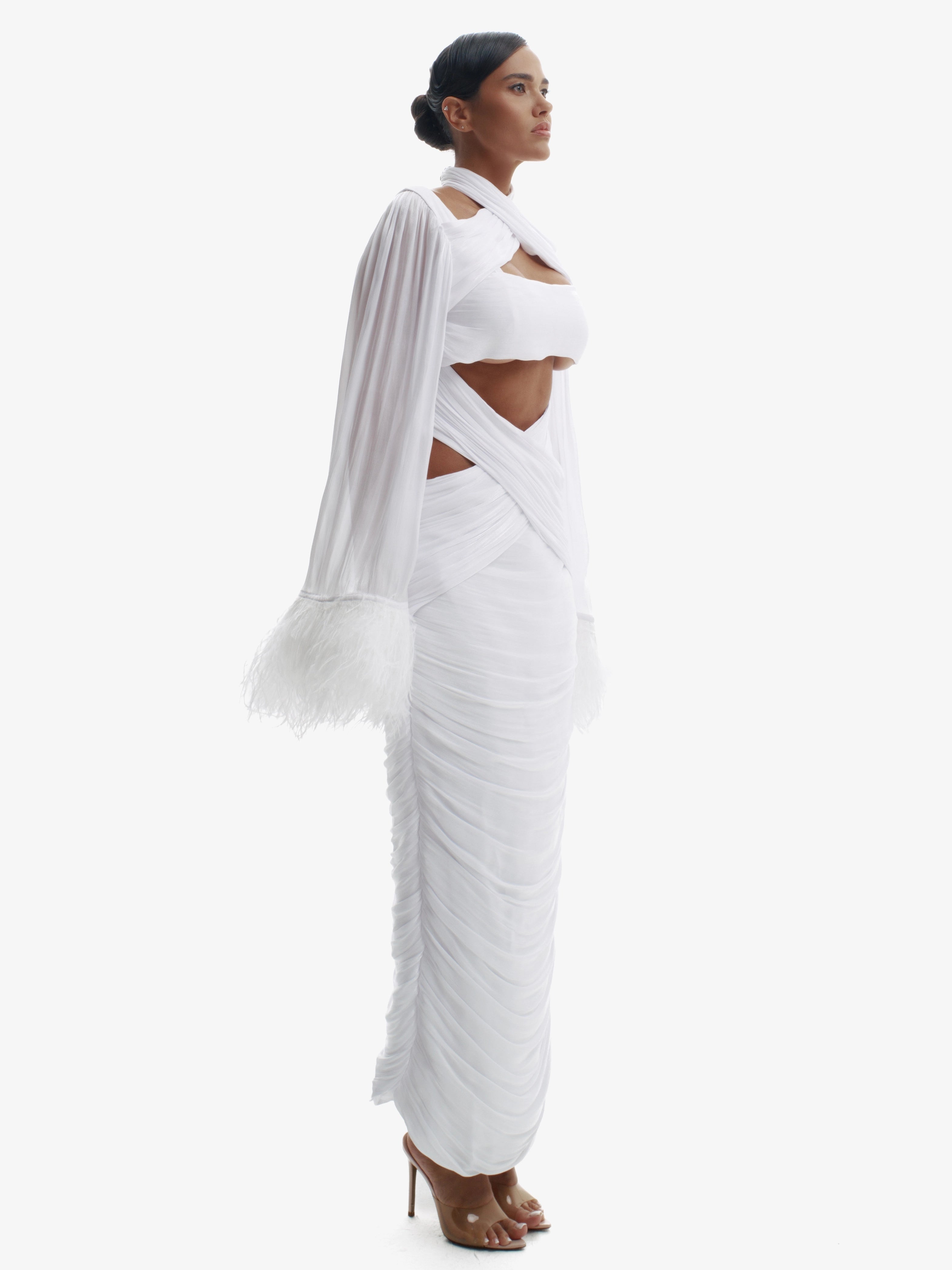 Woman wearing a white saree with a plain background